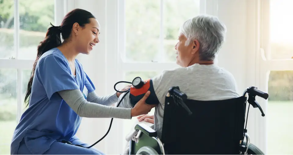 Nurse checking patient's blood pressure.